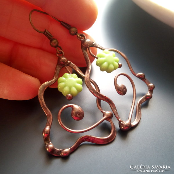 Glass beads in the shape of a green flower and earrings made of copper wire