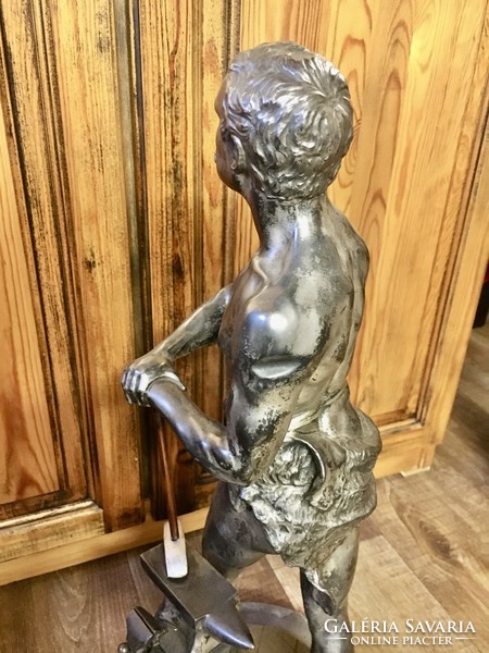 Vintage retro master blacksmith statue on a marble base. 60 cm high