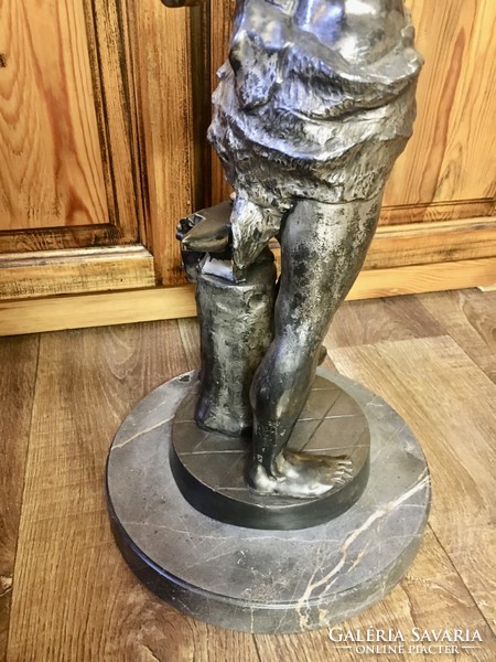 Vintage retro master blacksmith statue on a marble base. 60 cm high