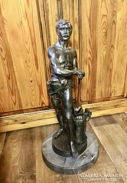 Vintage retro master blacksmith statue on a marble base. 60 cm high