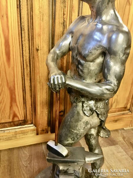 Vintage retro master blacksmith statue on a marble base. 60 cm high