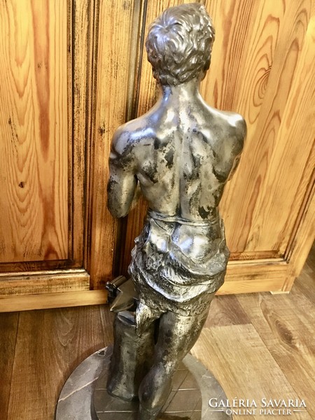 Vintage retro master blacksmith statue on a marble base. 60 cm high