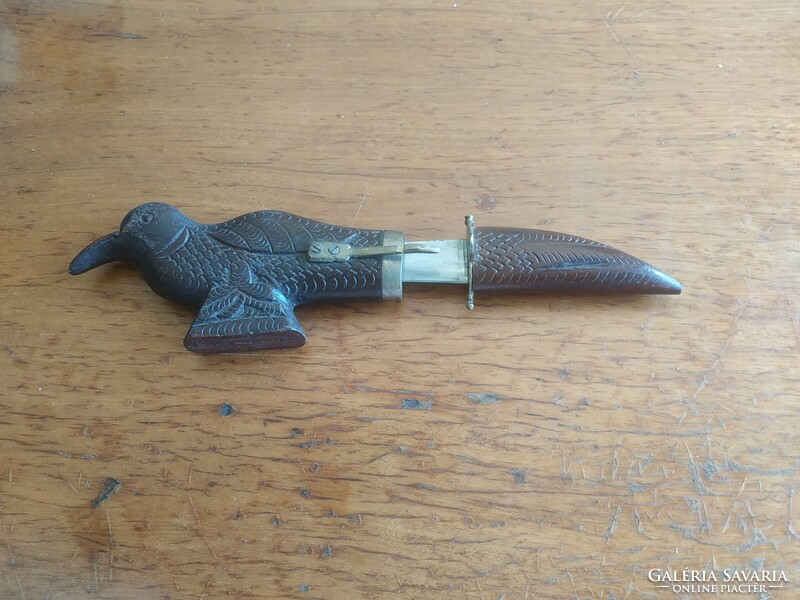 Retro carved bird figurine with knife