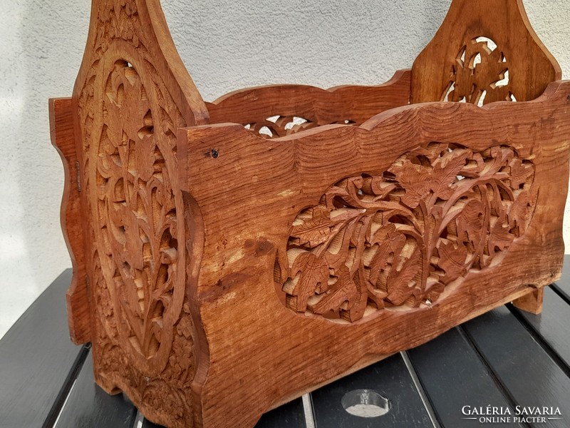 The whole thing is carved into a round, beautifully hand-carved wooden newspaper stand