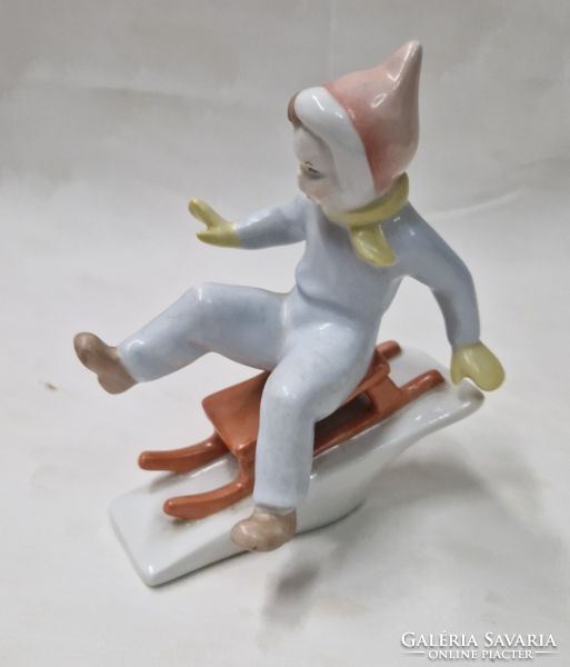 Aquincum porcelain sledding boy figure in perfect condition 11 cm.