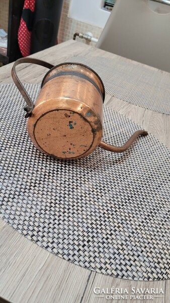 Handmade antique red copper watering can.