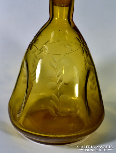 Amber colored liqueur bottle with an interesting shape with a polished cork