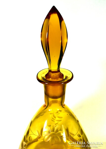 Amber colored liqueur bottle with an interesting shape with a polished cork