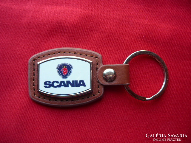 Scania metal keychain on leather background
