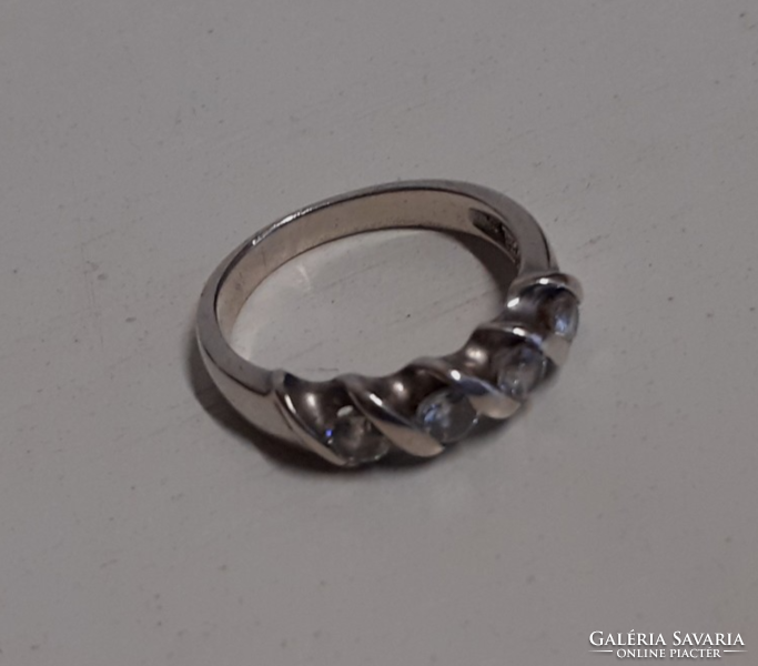 A marked silver ring in old, beautiful condition, set with white polished stones in a patterned setting
