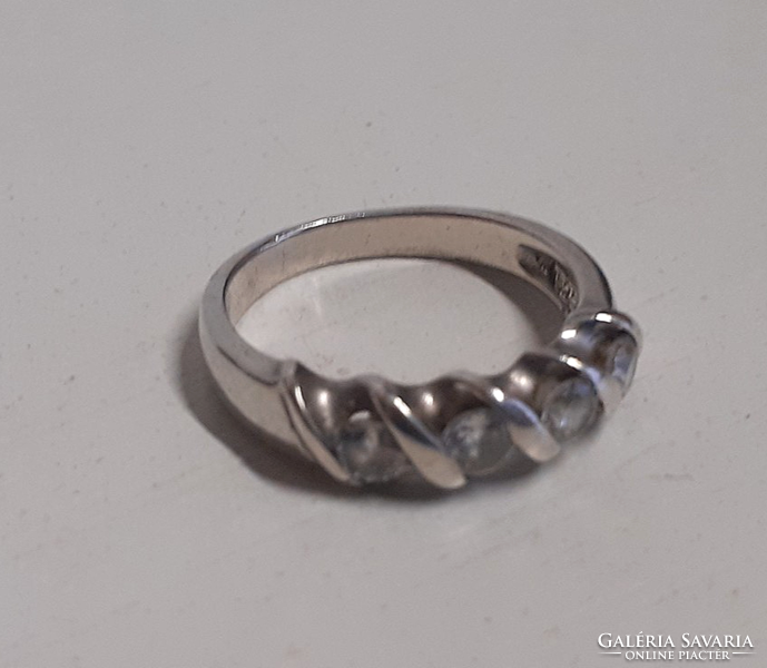 A marked silver ring in old, beautiful condition, set with white polished stones in a patterned setting