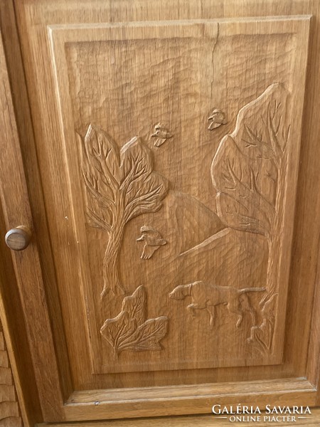 Carved oak corner cabinet/chest with hunting motifs