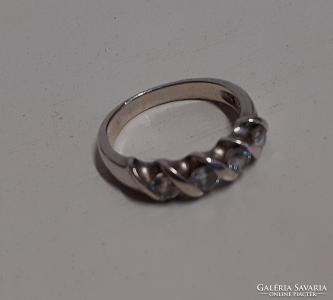 A marked silver ring in old, beautiful condition, set with white polished stones in a patterned setting