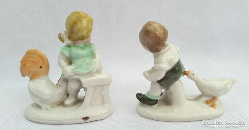 Pair of antique figural hand-painted porcelain statues