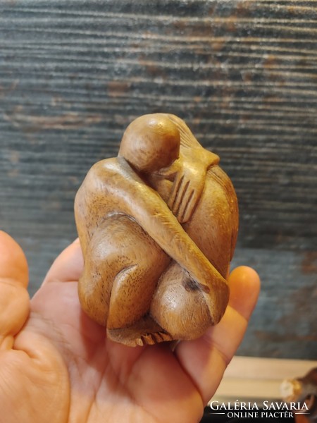 Carved wooden couple of naked lovers hugging
