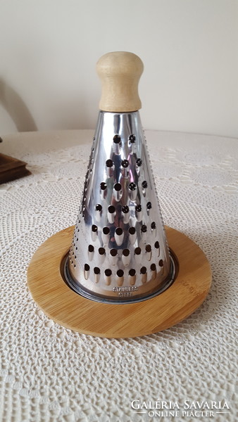 Stainless steel cheese grater on a bamboo base