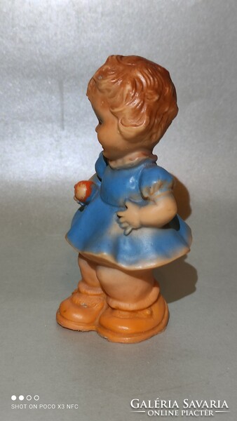 Old rubber figure of a little girl with an apple from the 50s