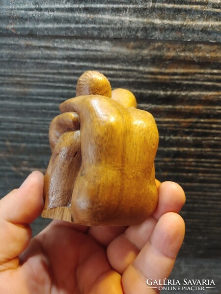 Carved wooden couple of naked lovers hugging