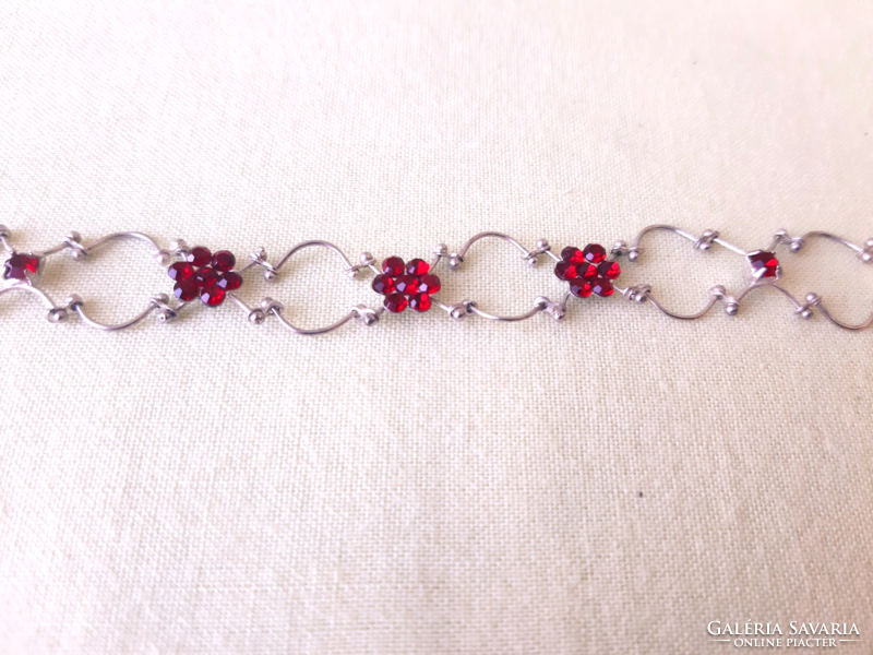 On a silver background, ruby red stone necklace, neck strap