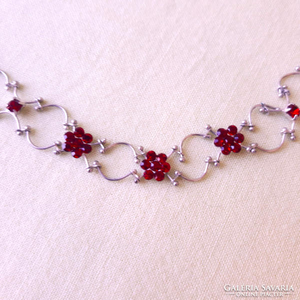 On a silver background, ruby red stone necklace, neck strap