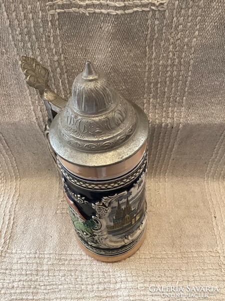 A half-liter ceramic jug with a lid depicting the skyline of Cologne