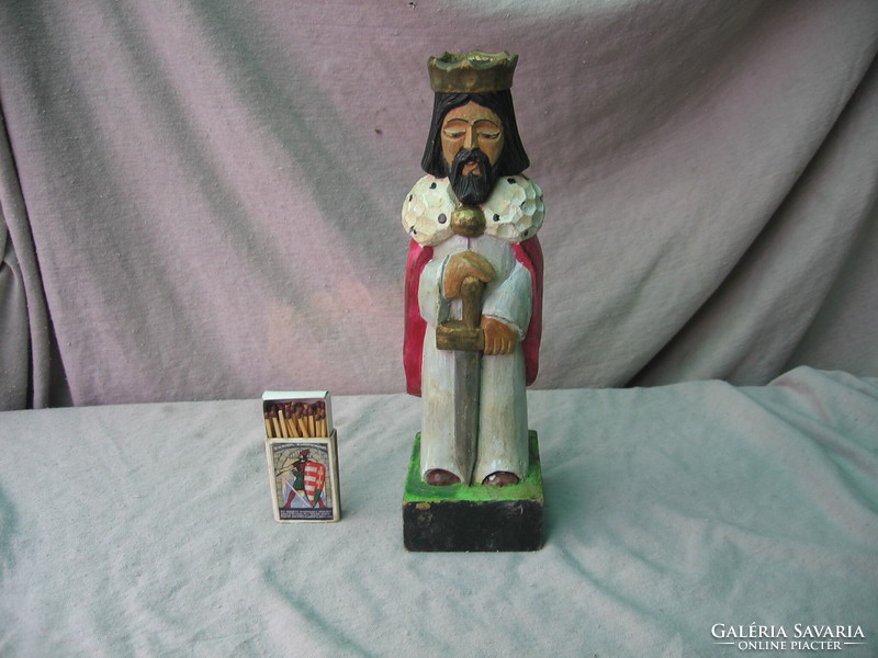 Old carved, painted, crowned, sword, wooden statue