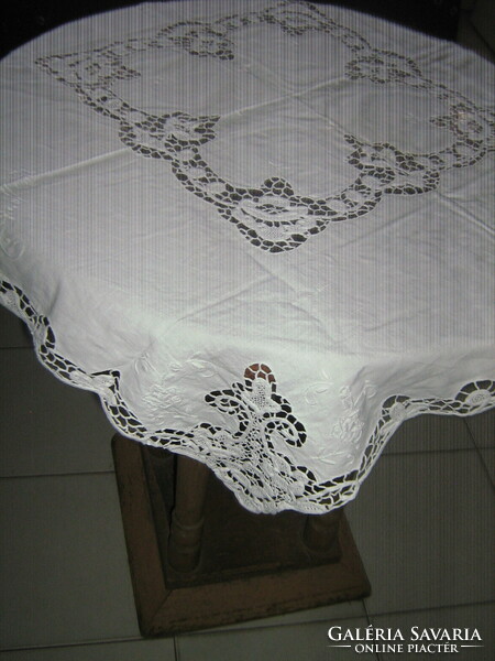 Beautiful ribbon embroidered on white lace tablecloth