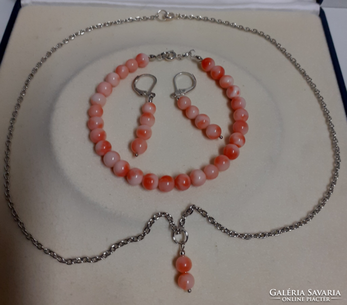 A beautiful coral eye pendant on a steel chain with a matching bracelet and earring set