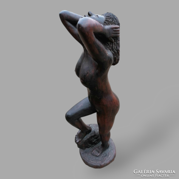 Signed female nude statue made of wood