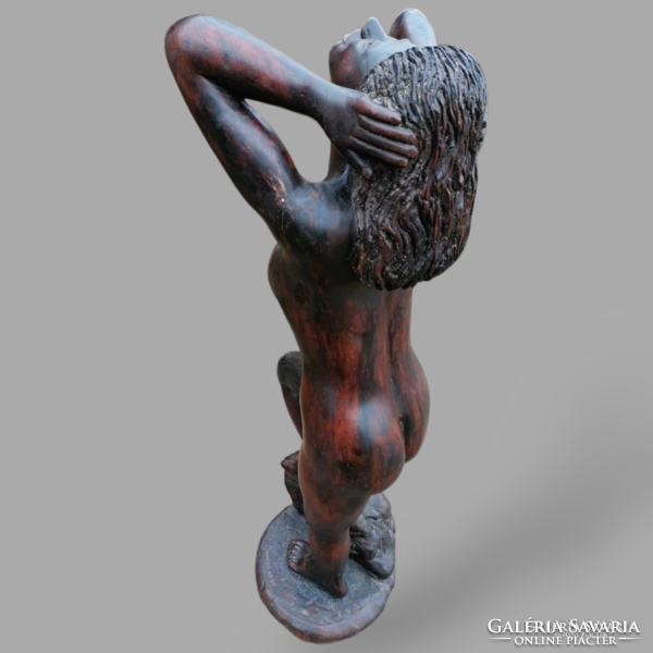 Signed female nude statue made of wood