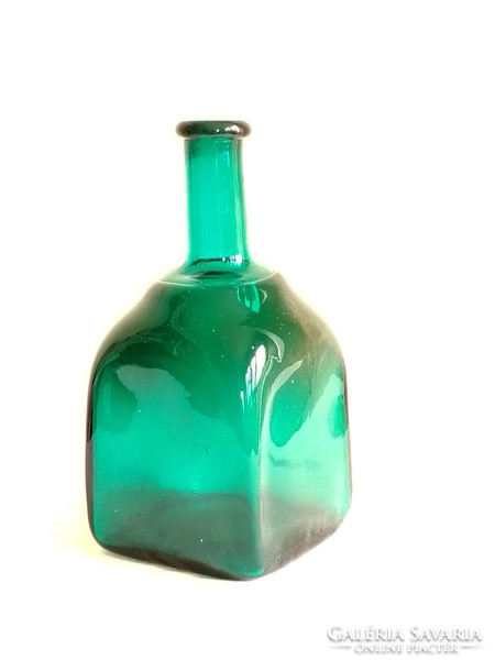 Old dark turquoise green colored square tweezers in the shape of blown glass bottles are beautiful for decoration