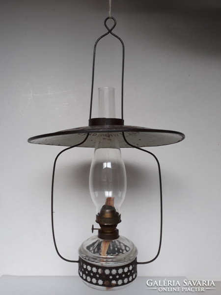 Antique hanging kerosene lamp from a farmhouse with lamp factory shade