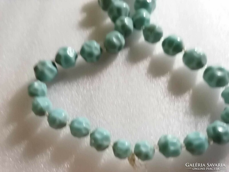 An interesting string of pale mint colored pearls