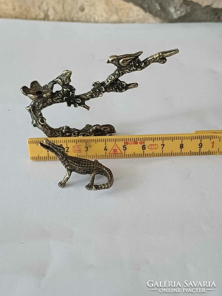 Copper mini sculptures of birds on tree branches and crocodiles