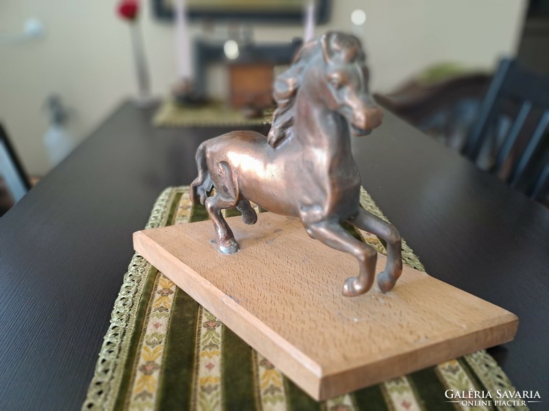 Bronzed horse on pedestal