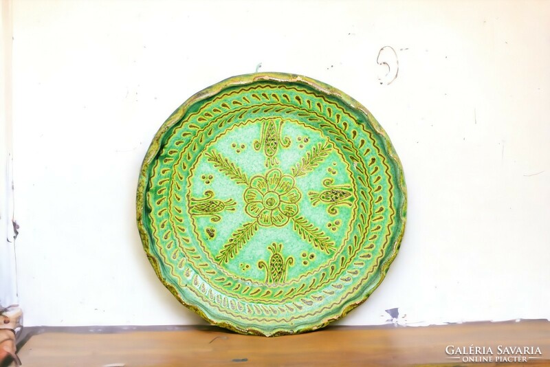 Old glazed green ceramic marked wall plate