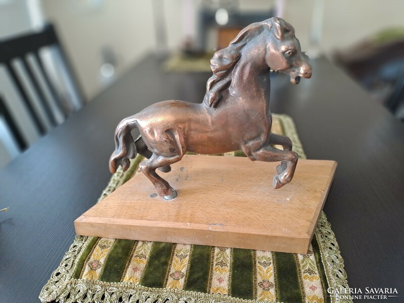 Bronzed horse on pedestal