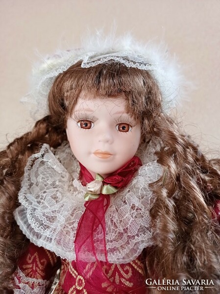 Doll with porcelain head on stand 40 cm