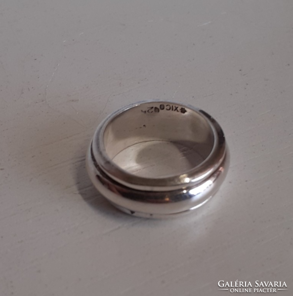 Marked silver ring with a small center swivel