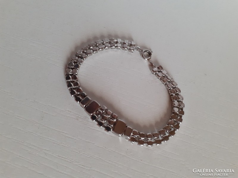 Old white bracelet studded with polished rhinestones