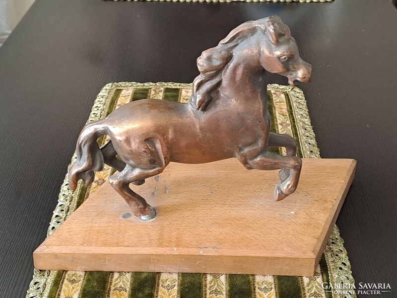 Bronzed horse on pedestal