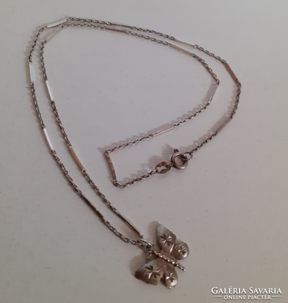 A marked silver necklace with a stamped silver butterfly pendant in good condition