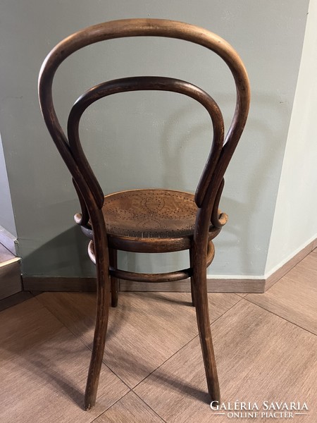 Antique thonet chair made of bent wood, with wonderful wear on the surface, with a drilled pattern on the anvil surface