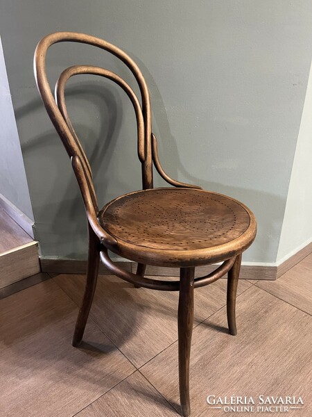 Antique thonet chair made of bent wood, with wonderful wear on the surface, with a drilled pattern on the anvil surface