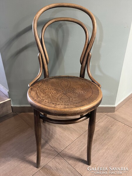 Antique thonet chair made of bent wood, with wonderful wear on the surface, with a drilled pattern on the anvil surface