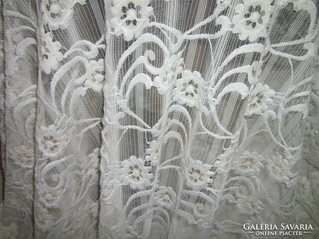 A white curtain richly embroidered in a beautiful material