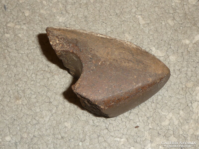 Fragment of an old stone ax An original polished stone ax from the Neolithic or Bronze Age