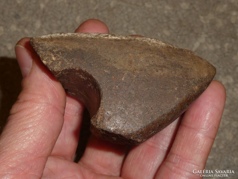 Fragment of an old stone ax An original polished stone ax from the Neolithic or Bronze Age