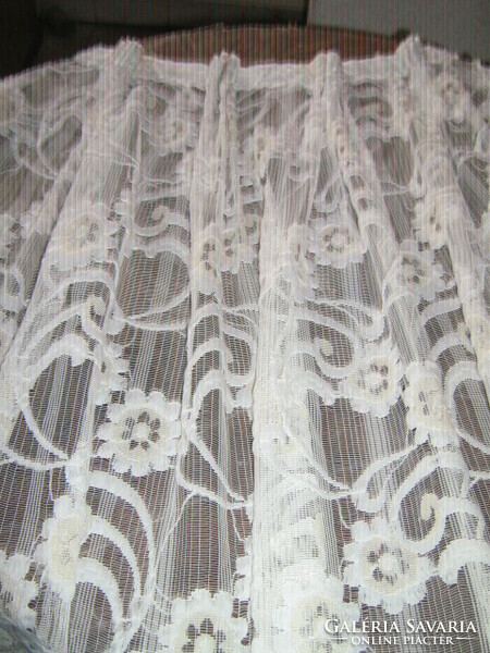 A white curtain richly embroidered in a beautiful material