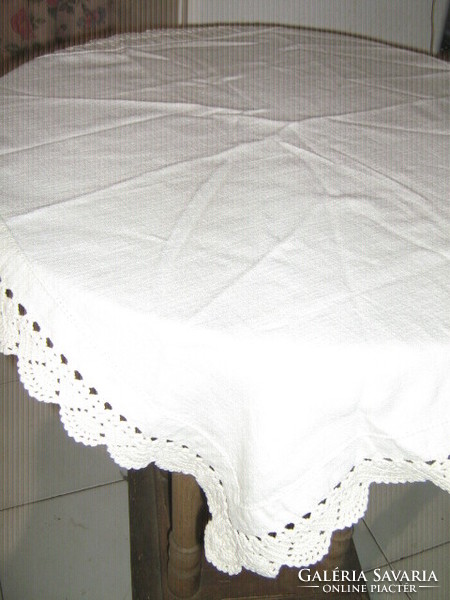 A charming hand-crocheted woven tablecloth with a lace edge